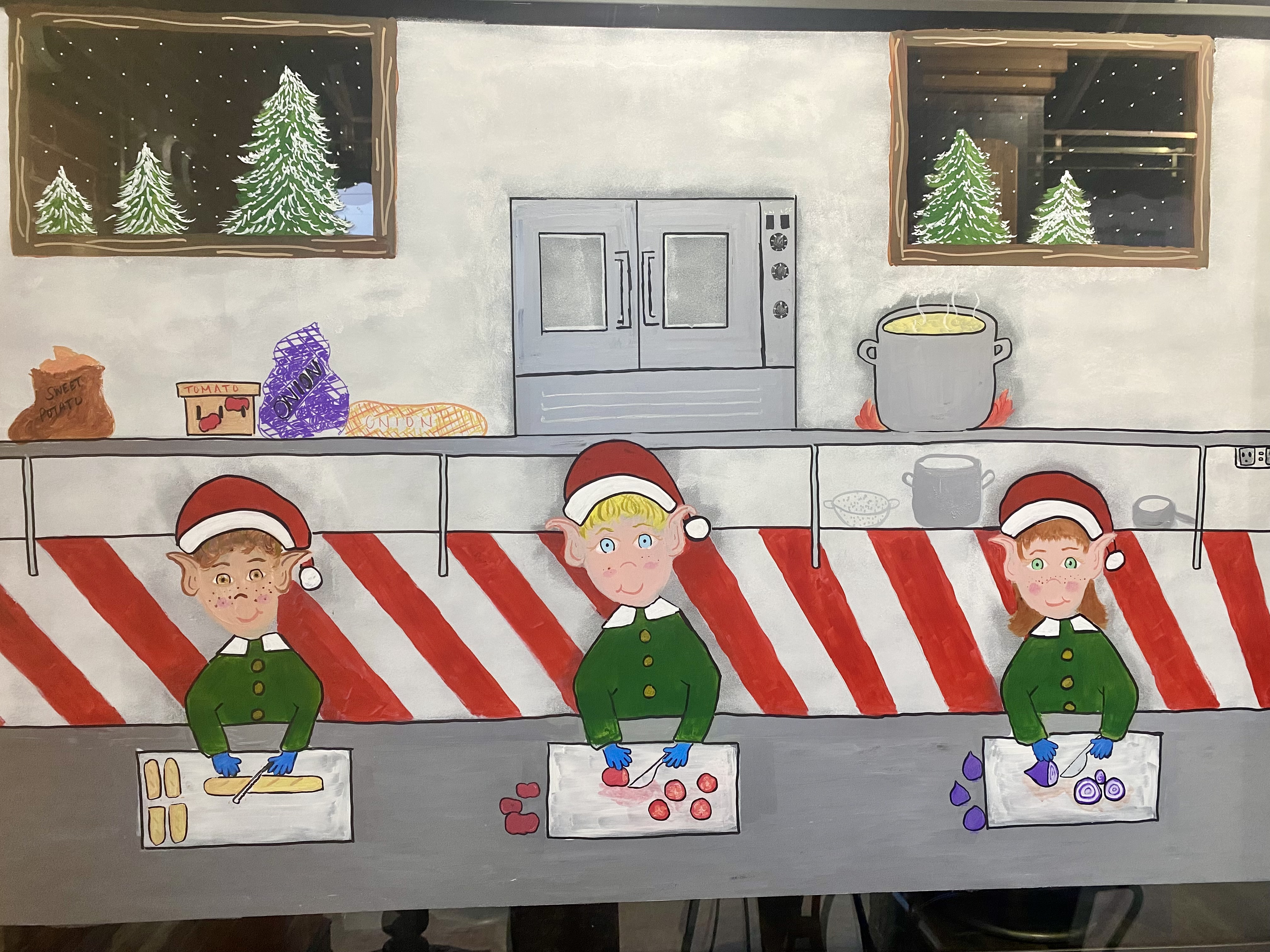 On the left window you see elves prepping the food in the kitchen getting ready to make Santa his Bistro Club Sandwich!